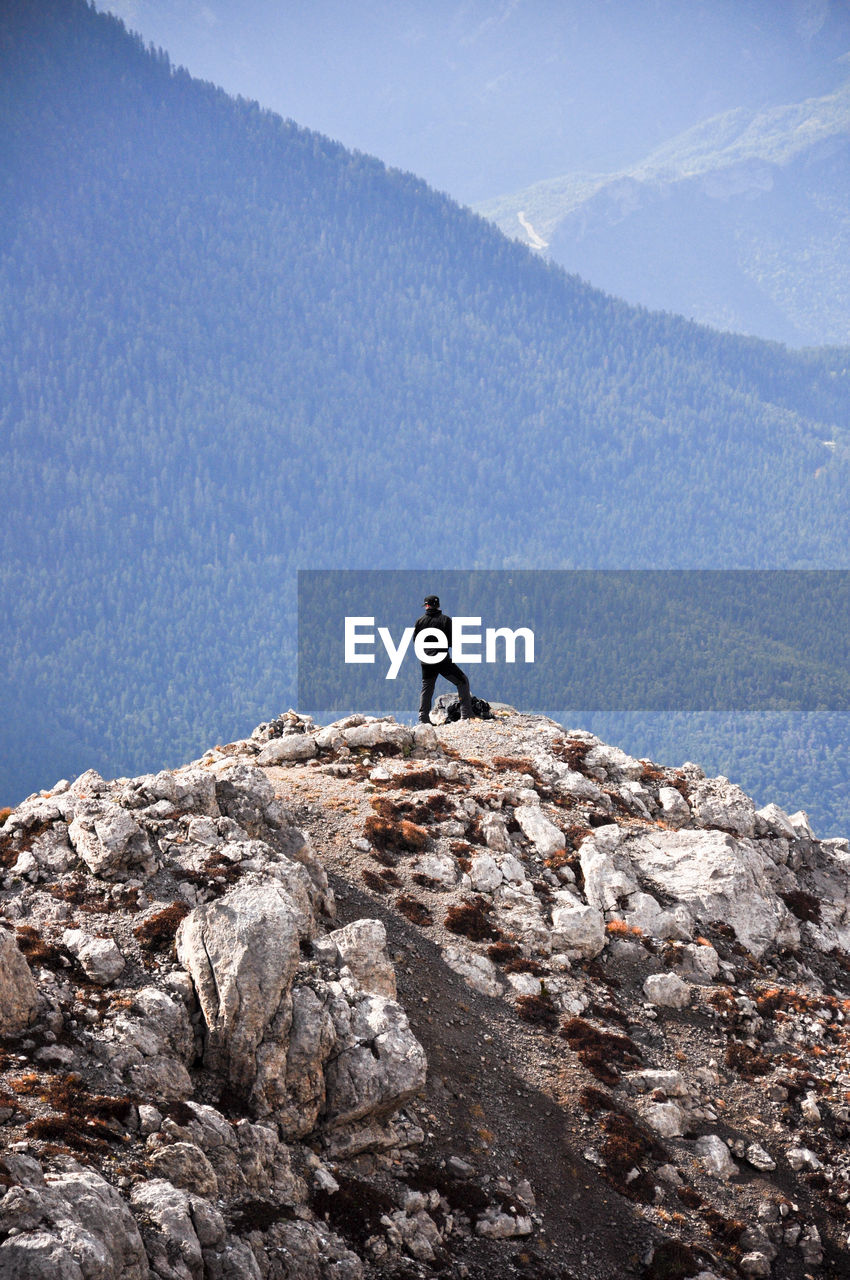 Man on rock against mountain