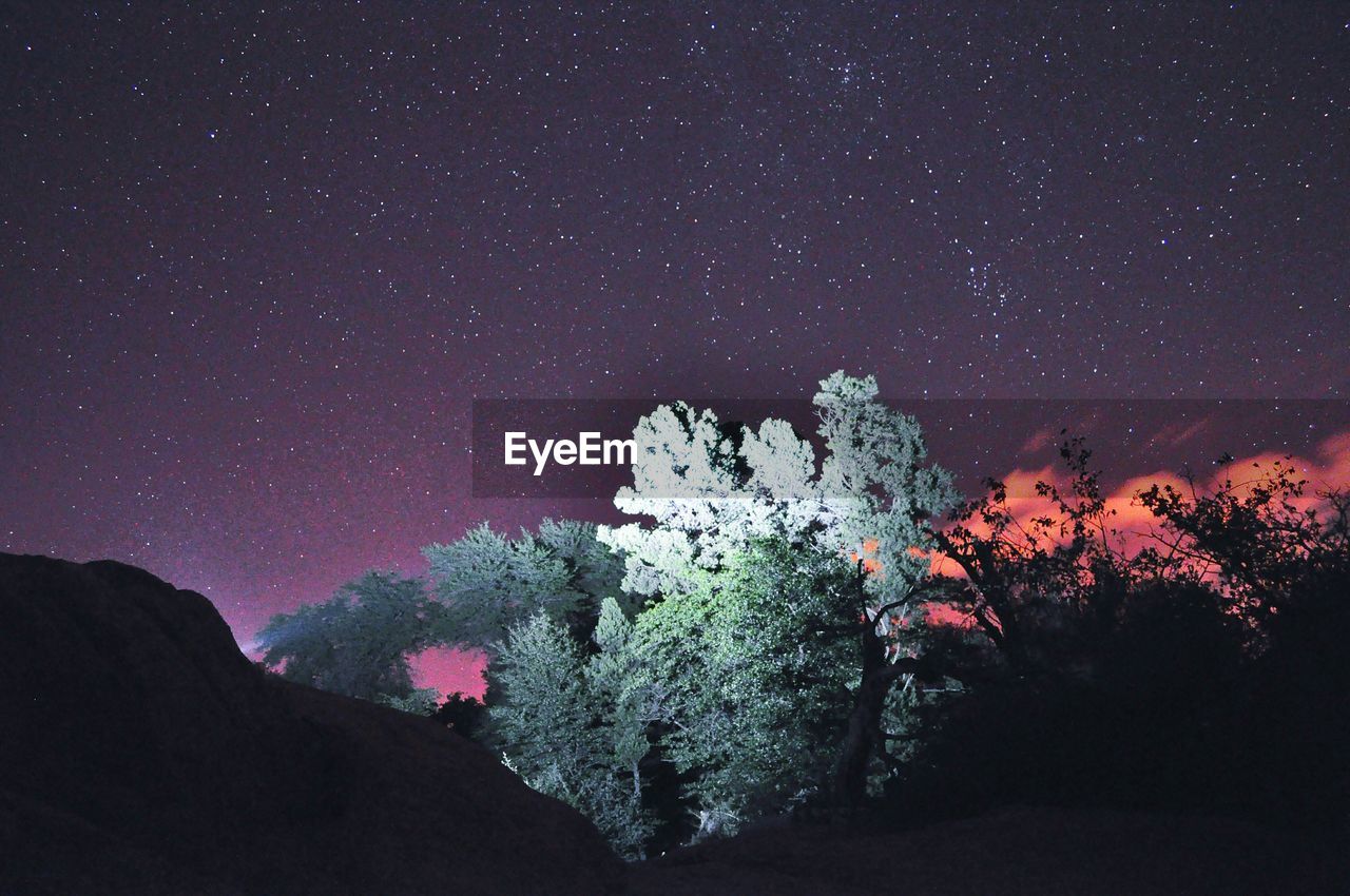 Scenic view of mountain against sky at night