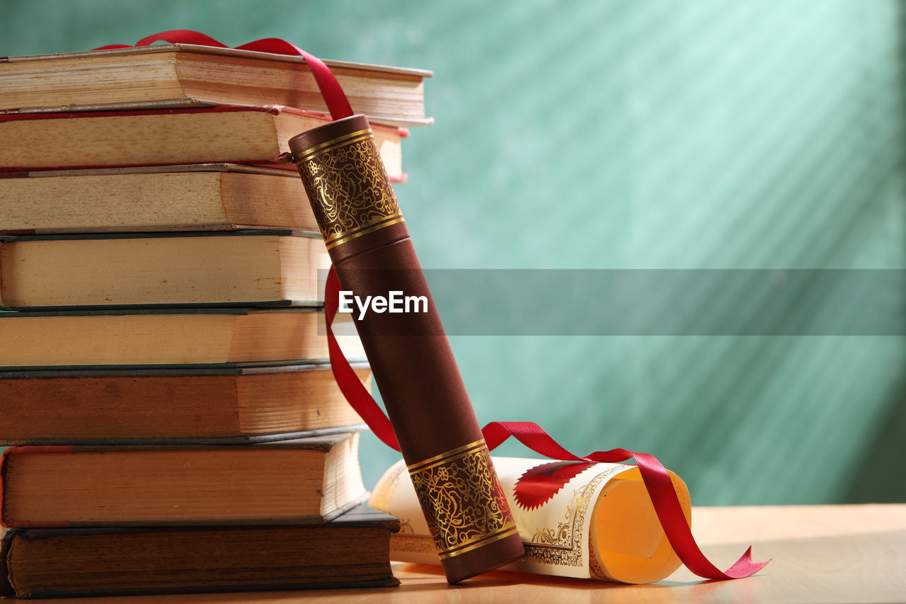 Close-up of books stacked against wall