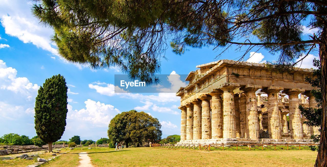 Low angle view of historical building against clear blue sky  , temple of paestum. italy