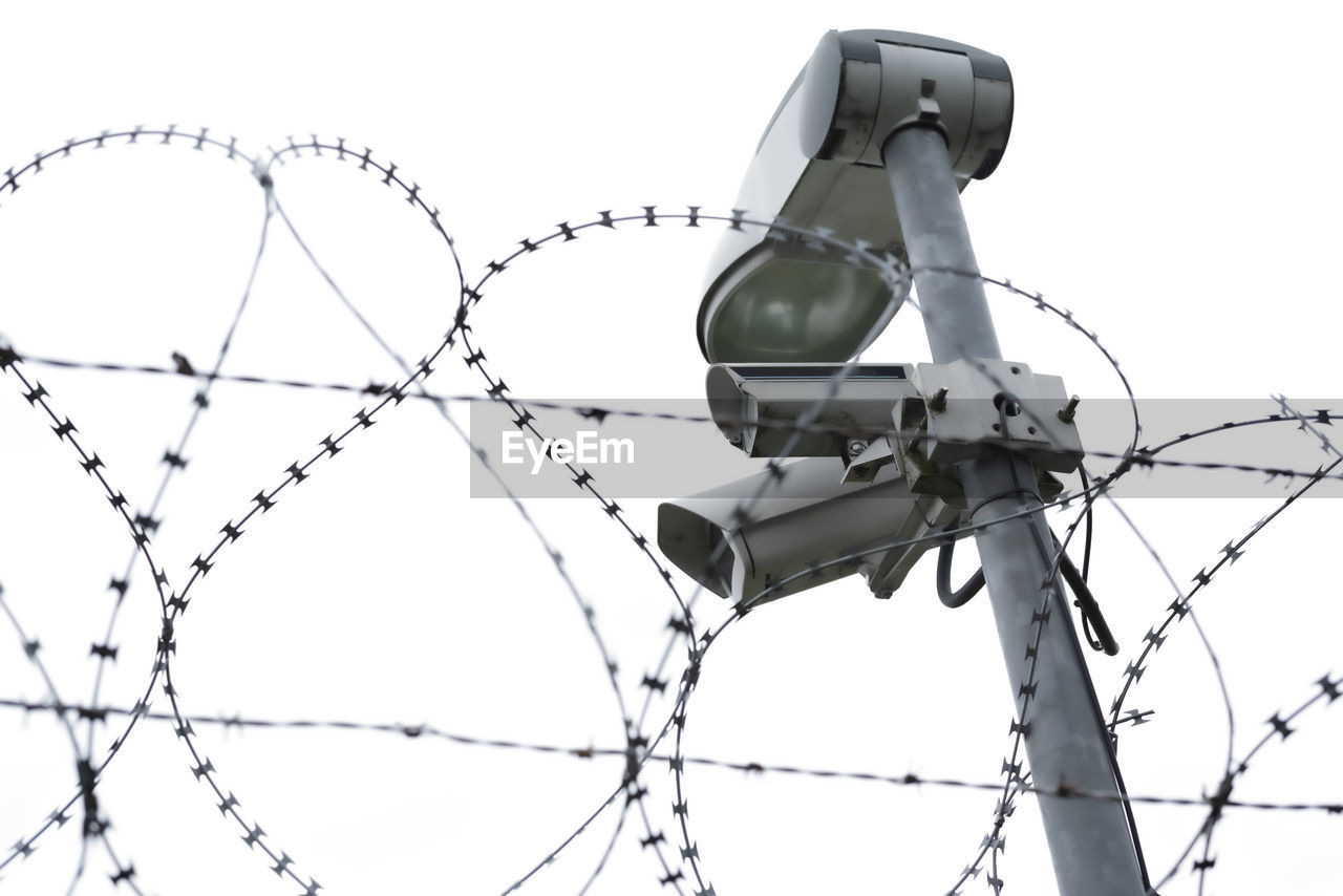 Low angle view of barbed wires against clear sky