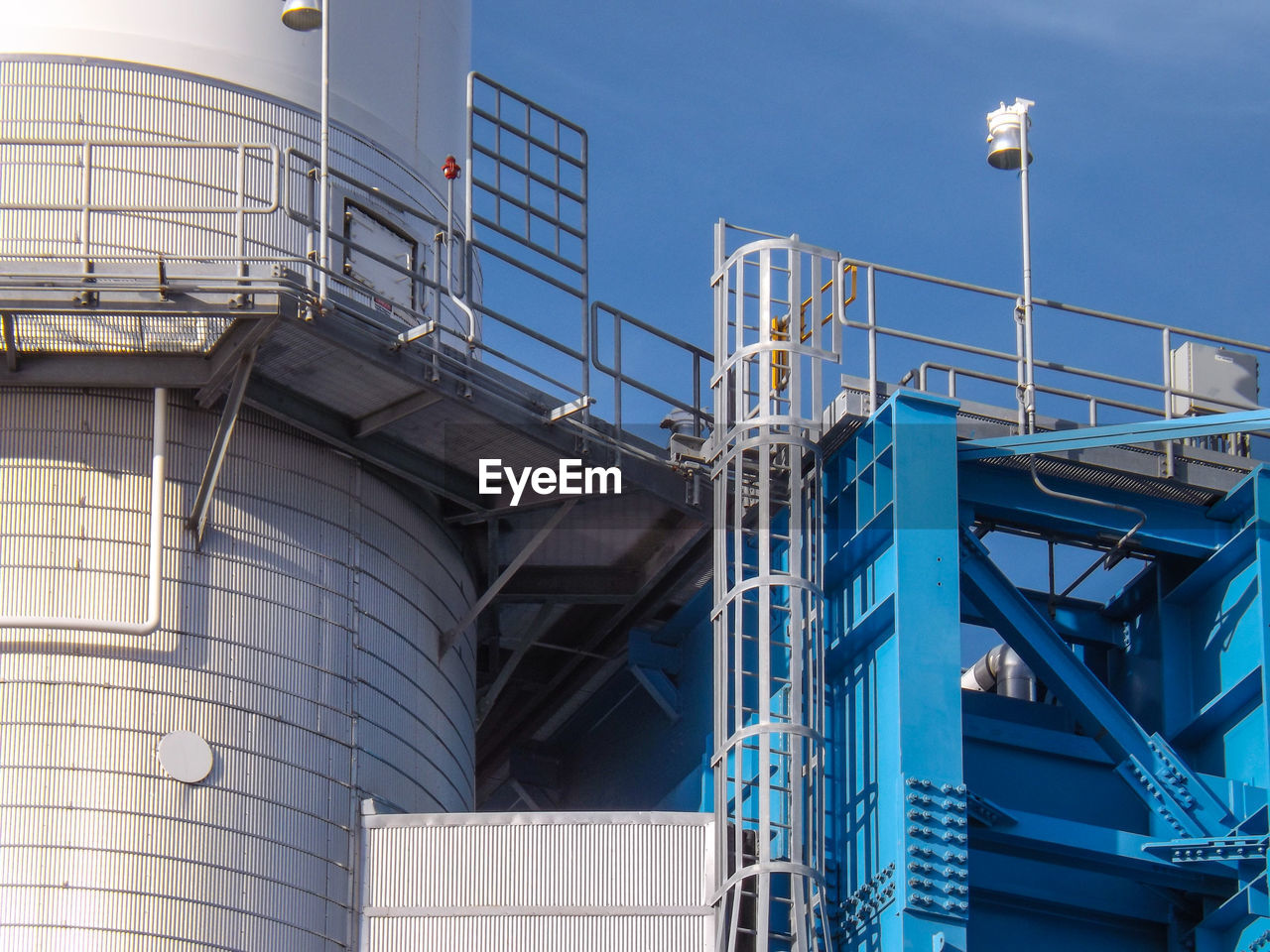 Low angle view of industrial building against sky