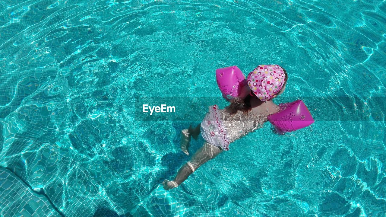 High angle view of girl swimming in pool