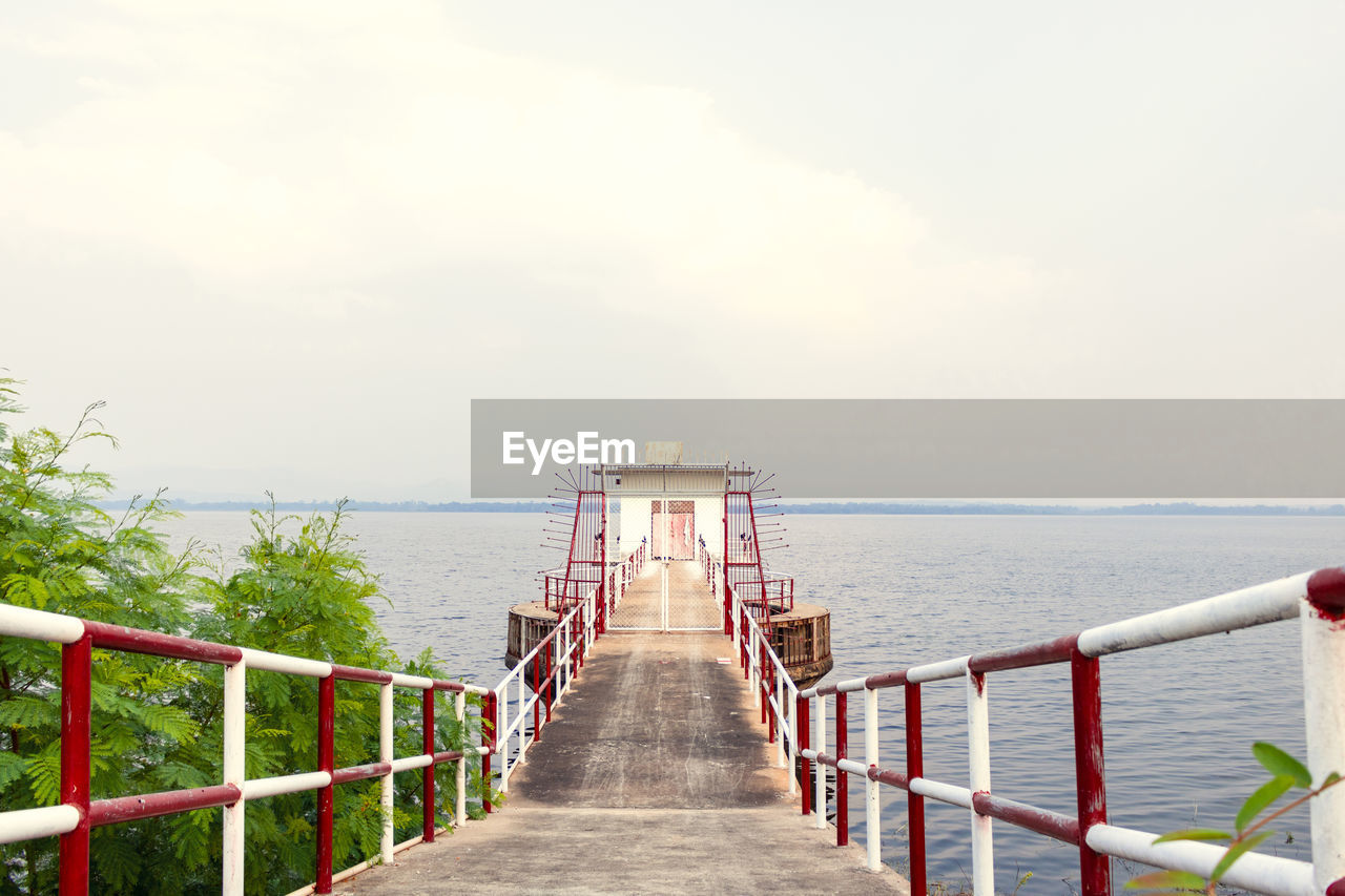 PIER LEADING TOWARDS SEA AGAINST SKY