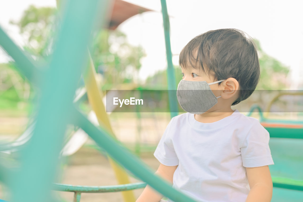 Full length of cute boy standing on playground