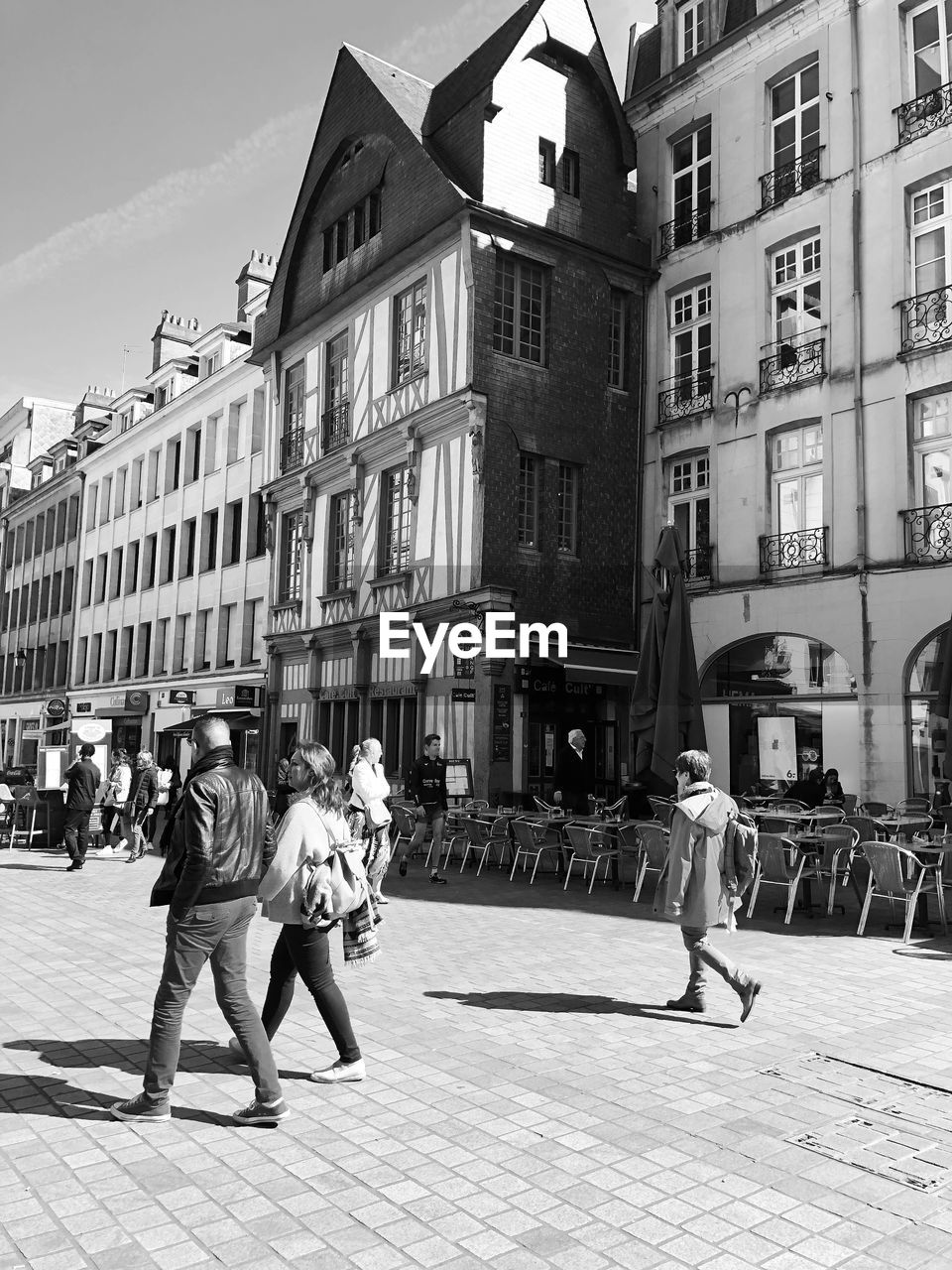 PEOPLE WALKING ON STREET IN CITY