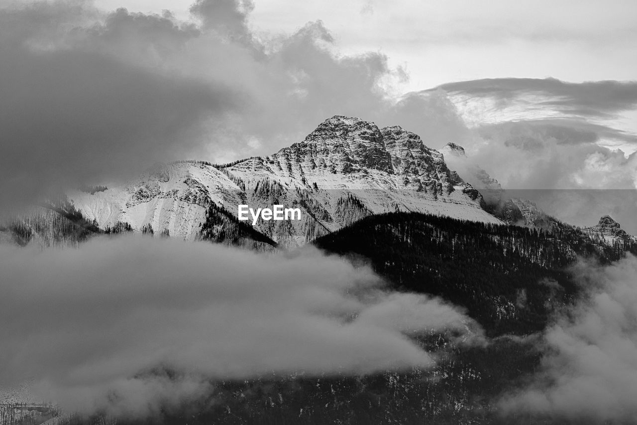 mountain, environment, snow, cloud, scenics - nature, landscape, sky, black and white, beauty in nature, nature, cold temperature, fog, monochrome, winter, monochrome photography, mountain peak, land, mountain range, snowcapped mountain, travel, travel destinations, mist, no people, outdoors, forest, tourism, tranquility, non-urban scene, tree, morning, plant, tranquil scene, activity, pinaceae, water, cloudscape, rock