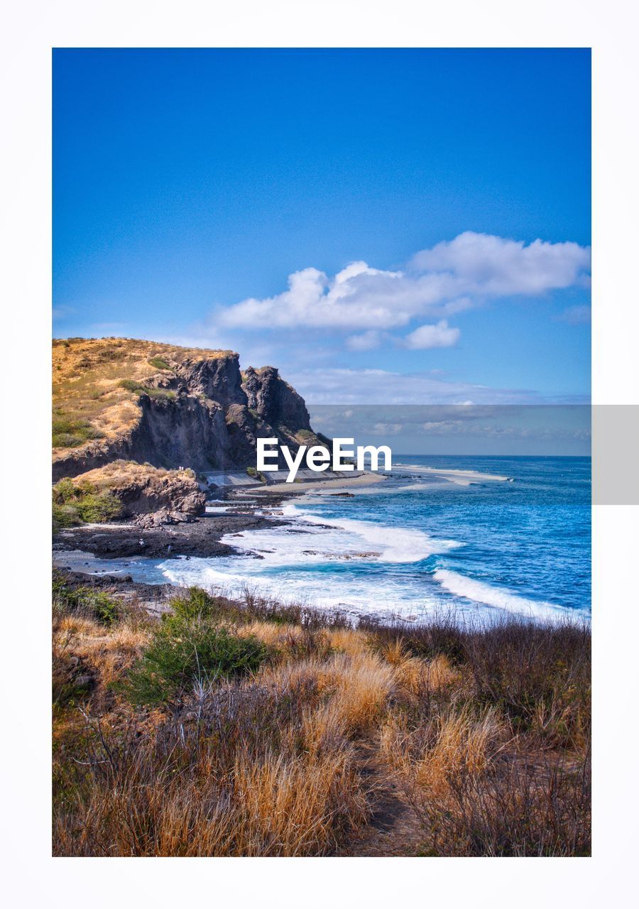 VIEW OF BEACH AGAINST BLUE SKY