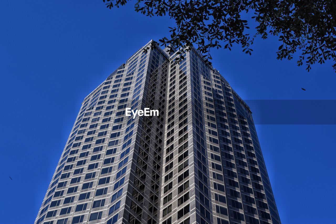 LOW ANGLE VIEW OF MODERN BUILDINGS AGAINST BLUE SKY