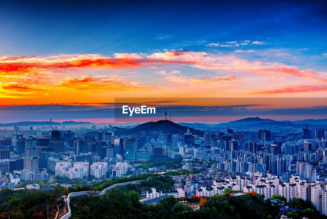 HIGH ANGLE VIEW OF BUILDINGS IN CITY DURING SUNSET