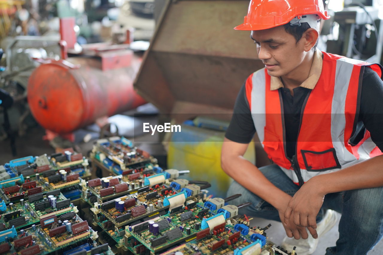 Portrait of male worker standing in the heavy industry manufacturing factory.