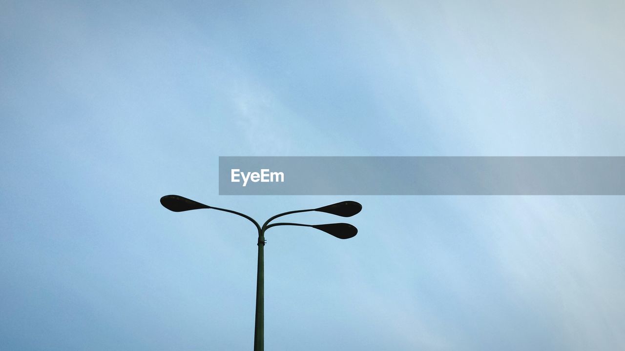 Low angle view of street light against sky