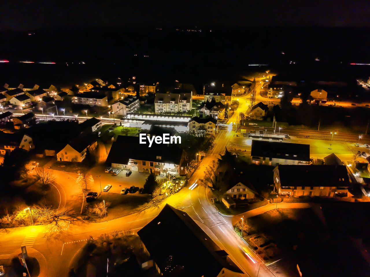 High angle view of illuminated street and buildings at night