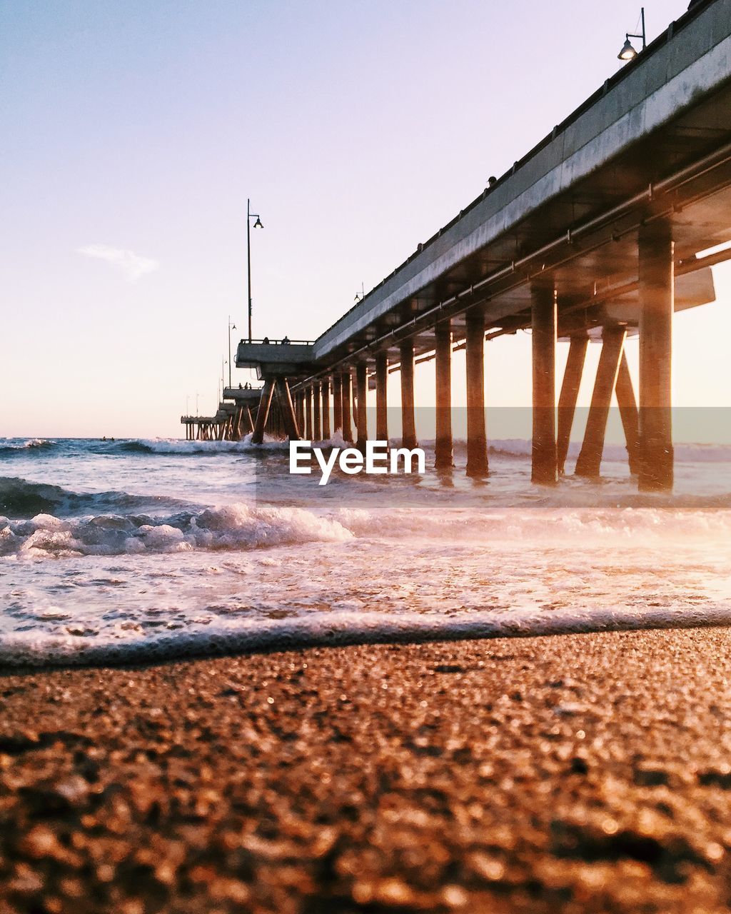 Low angle view of pier on beach