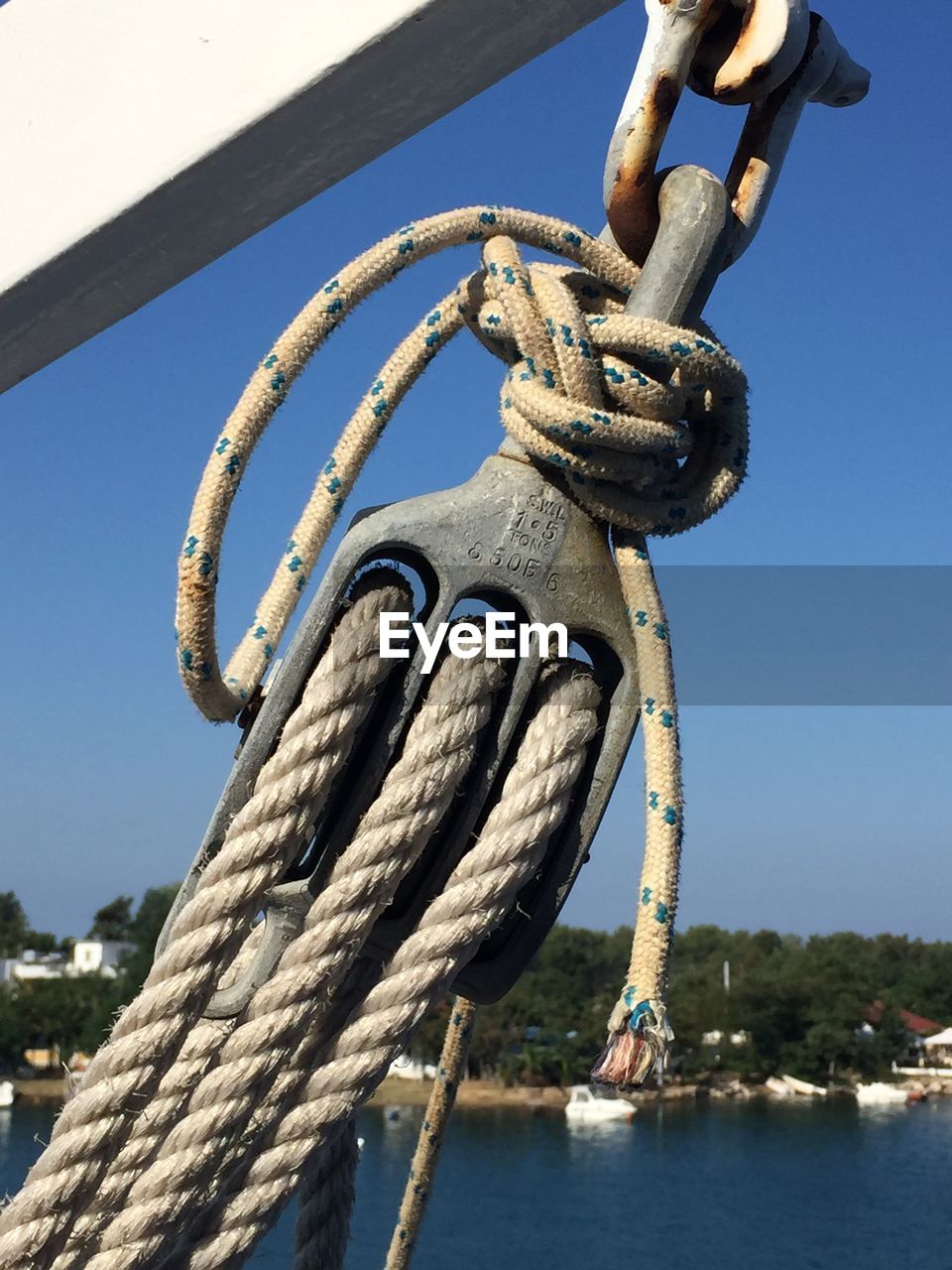 Close-up of sailboat pulley against sky