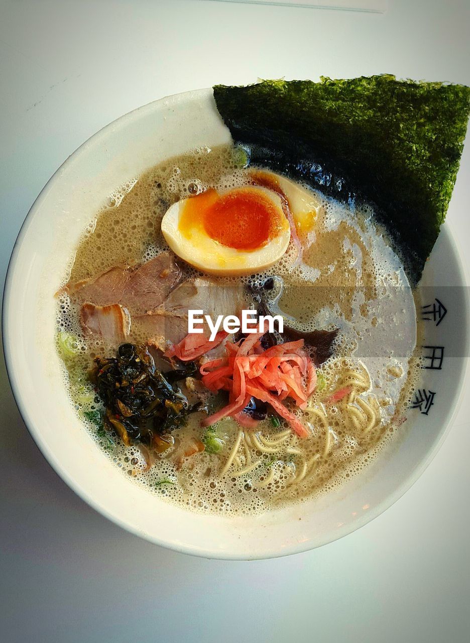 High angle view of ramen in bowl against white background