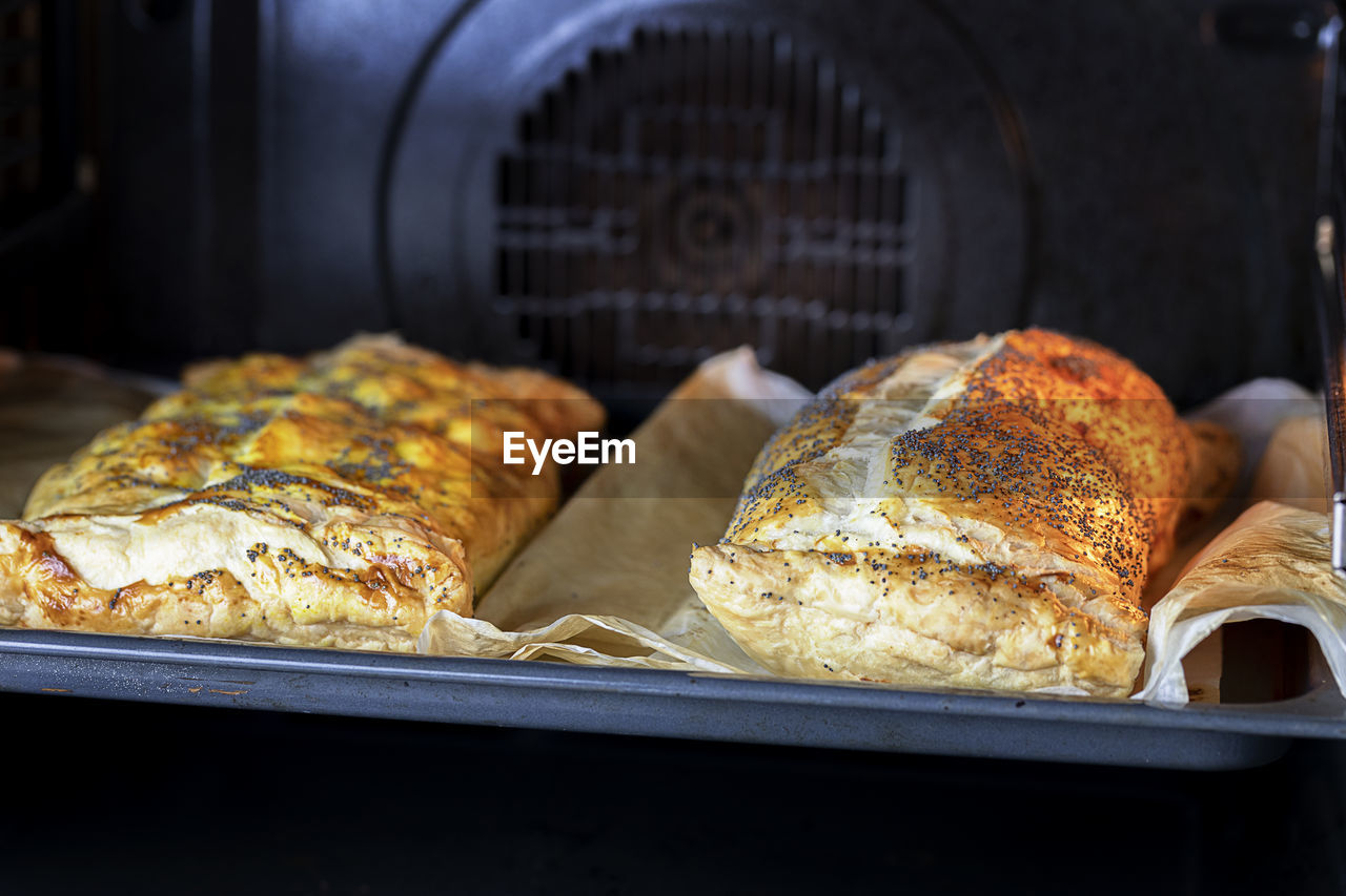 Two roll strudel cooking in an oven.