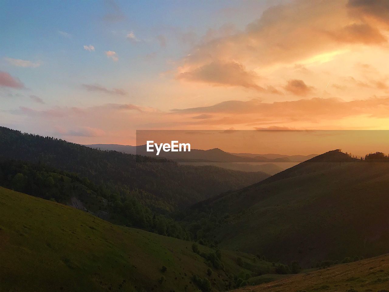 SCENIC VIEW OF MOUNTAIN AGAINST SKY DURING SUNSET