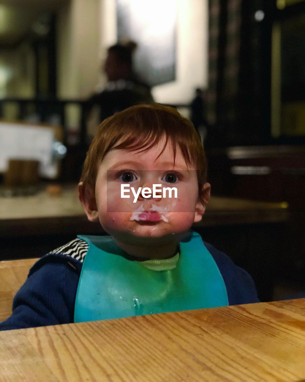 Close-up of cute baby boy sitting at restaurant