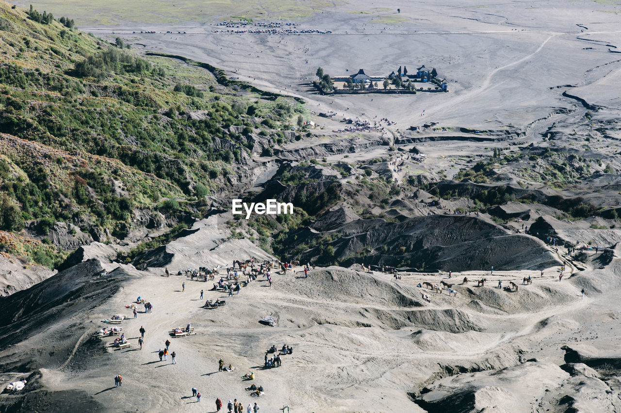 High angle view of people walking on mountain during sunny day