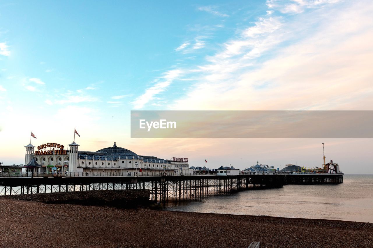 PIER OVER SEA AGAINST SKY AT SUNSET