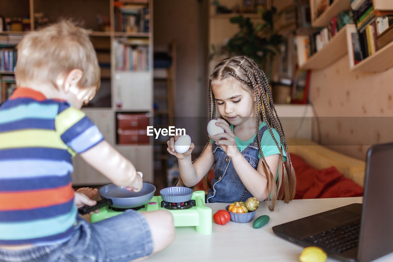 Cheerful kids with food on table