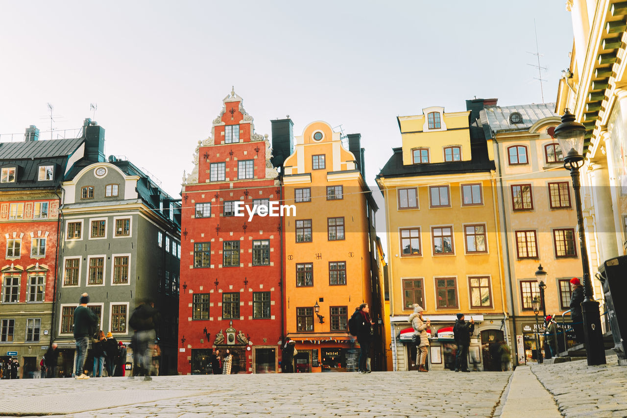 People standing in front of buildings in town