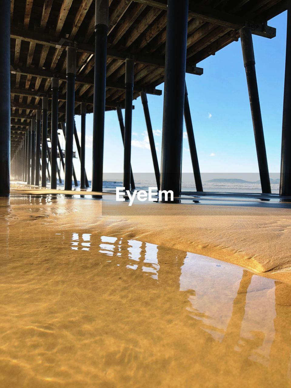 LOW ANGLE VIEW OF PIER ON BEACH