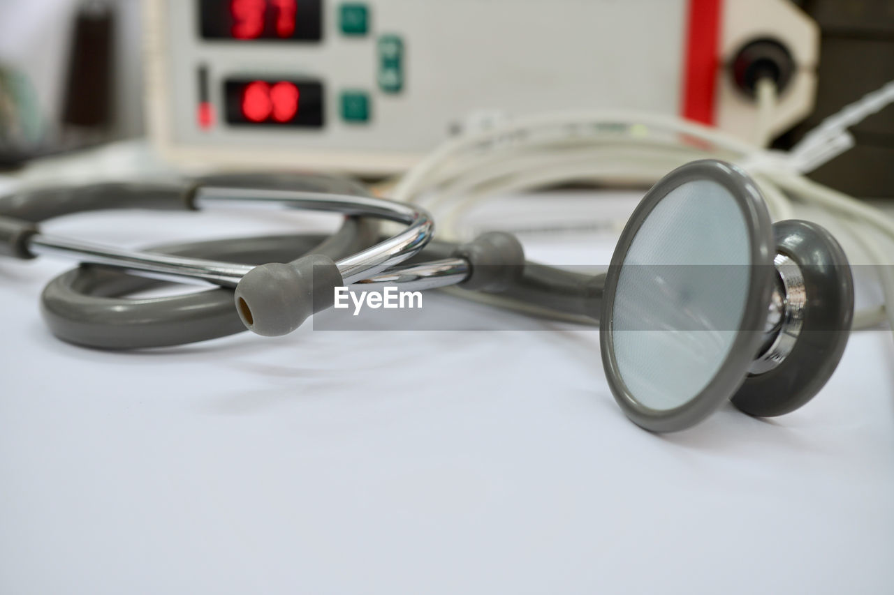 Close-up of stethoscope and monitoring equipment on table