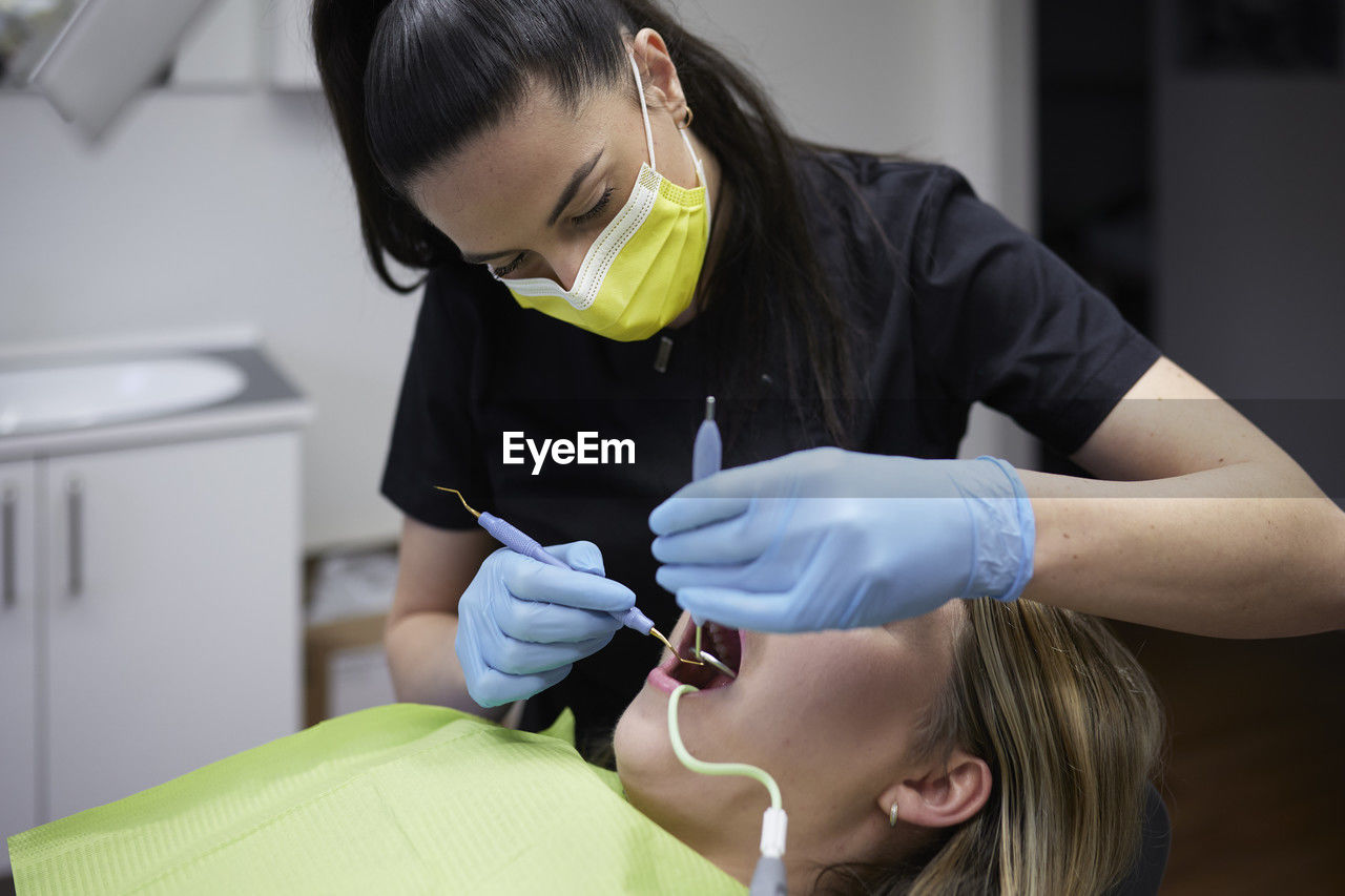 Female dentist with patient in office