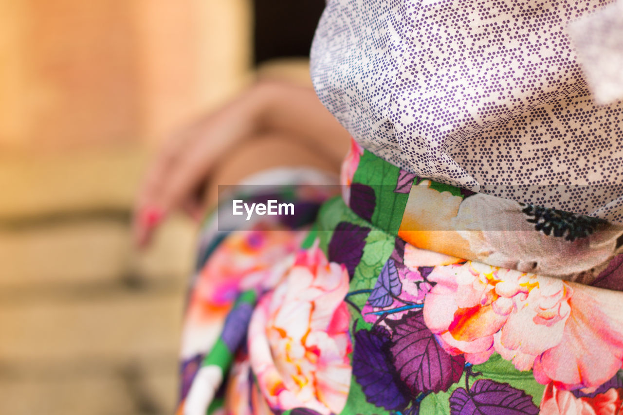 CLOSE-UP OF WOMAN WITH MULTI COLORED HAT