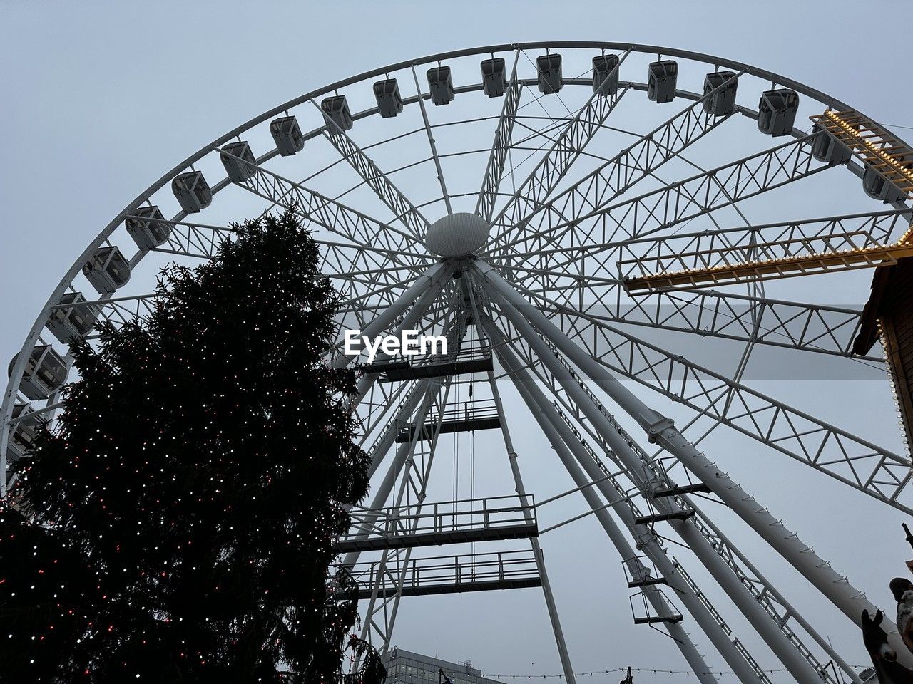 ferris wheel, amusement park, amusement park ride, arts culture and entertainment, sky, recreation, architecture, nature, carnival, leisure activity, built structure, low angle view, fun, traveling carnival, travel destinations, outdoors, no people, park, circle, enjoyment, amusement ride, shape, geometric shape, large, clear sky