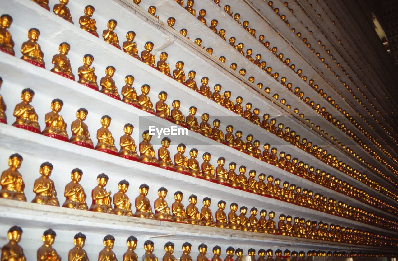 Full frame shot of statues in shelves for sale