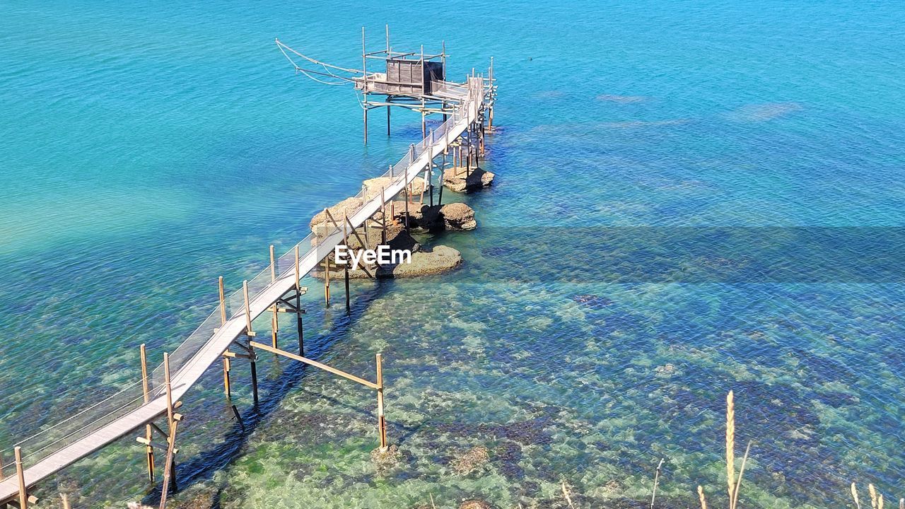 water, high angle view, sea, nature, day, coast, beauty in nature, tranquility, outdoors, no people, scenics - nature, tranquil scene, built structure, bay, architecture, transportation, railing, blue, sunlight, land, ocean, beach, idyllic, dock