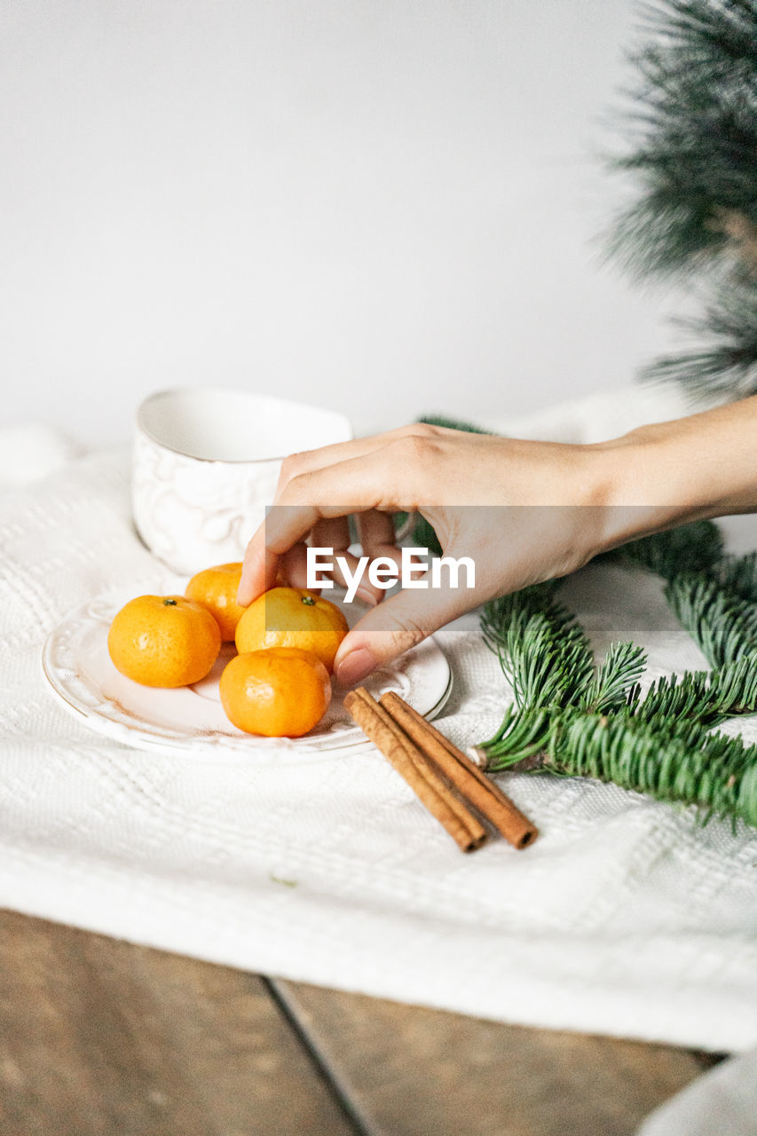 MIDSECTION OF WOMAN WITH FRUITS