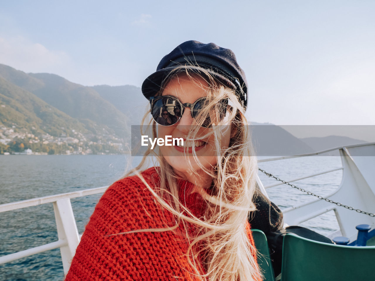 Close-up portrait of smiling young woman on boat sailing in sea