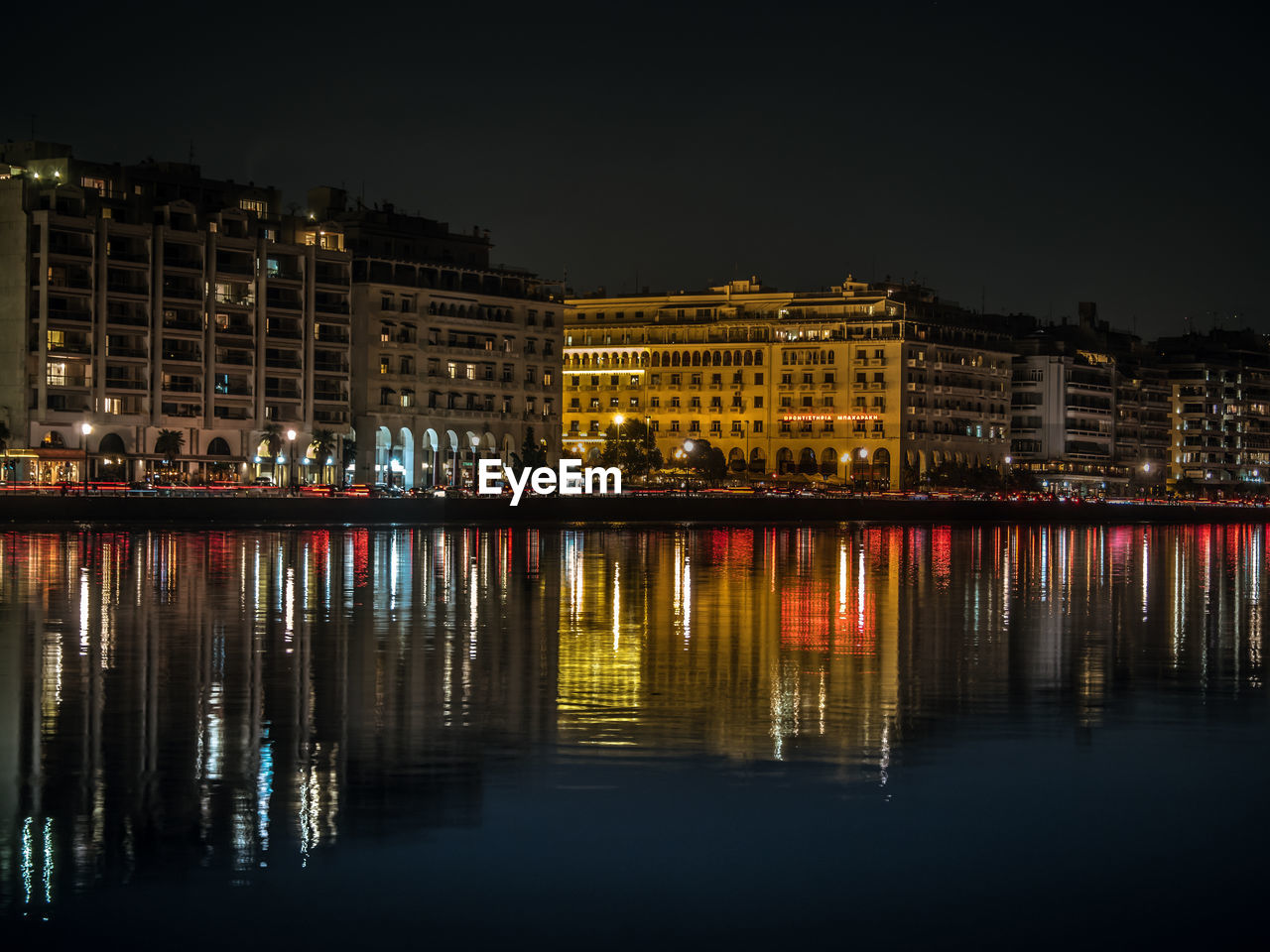 Reflection of illuminated buildings in water at night