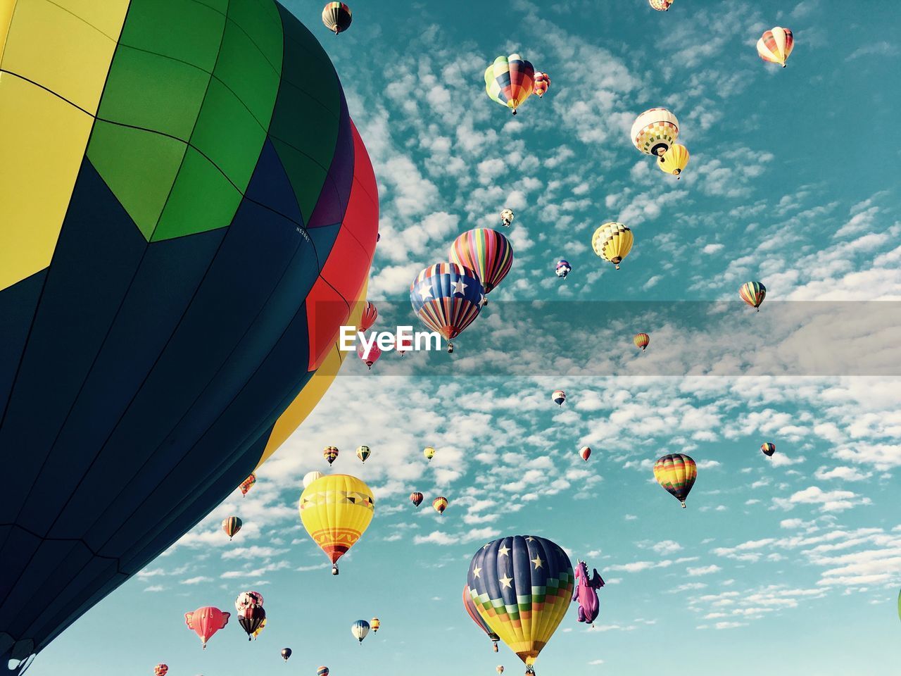 Low angle view of colorful hot air balloons against sky