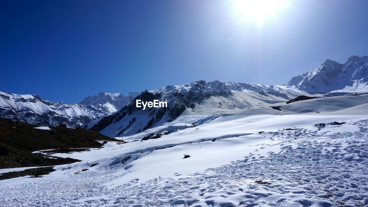 Scenic view of snowcapped mountains against clear sky