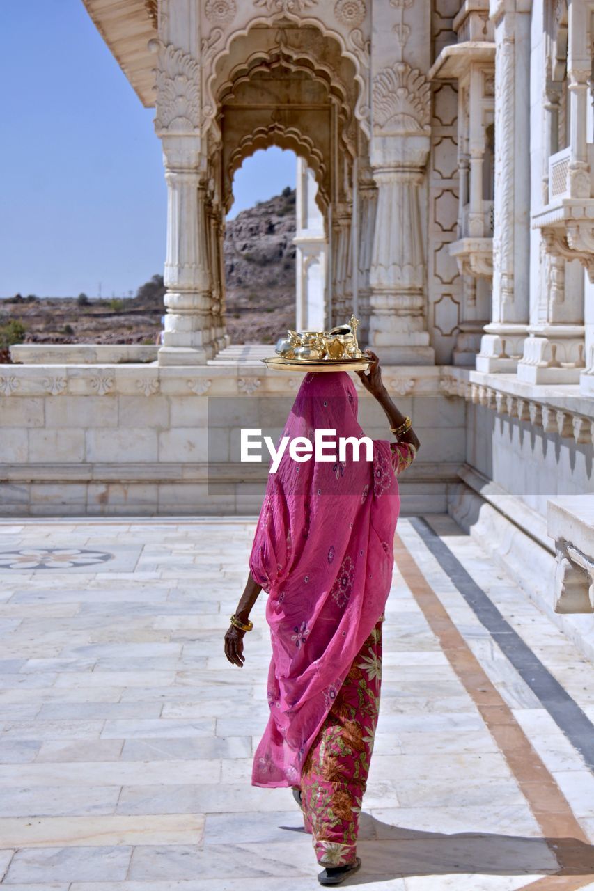 Rear view of woman walking in temple