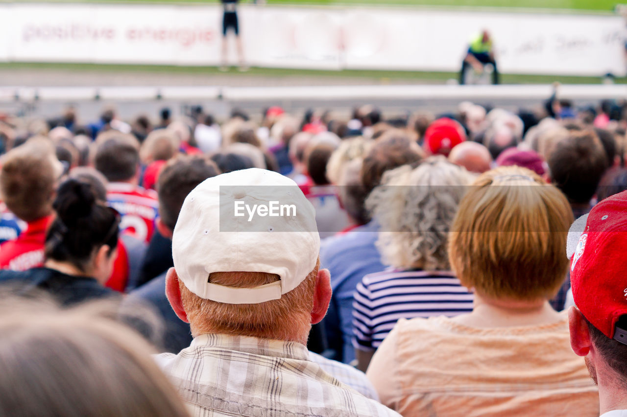 Crowd sitting on chair at stadium