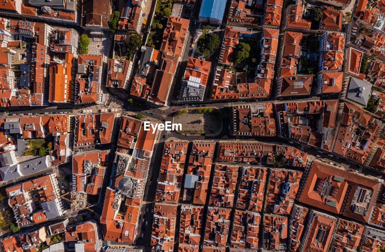 Overhead aerial of red roofs of buildings in historic center of city in lisbon, portugal.