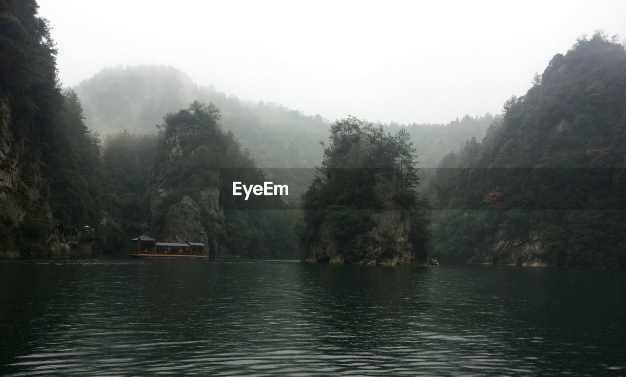 Scenic view of lake with trees in background