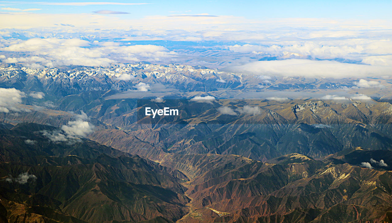 Aerial view of snowcapped mountains against sky