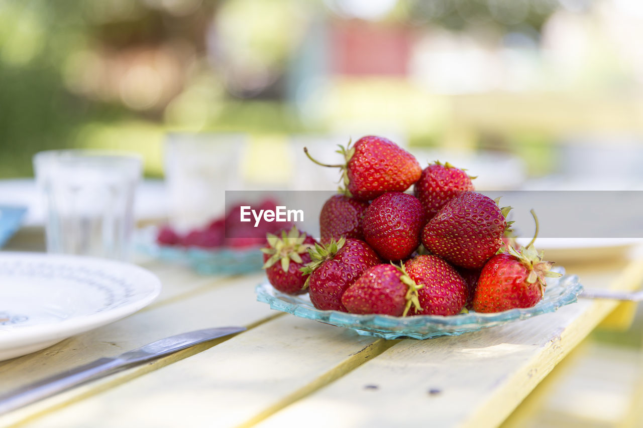 Close-up of strawberries on crystal plate