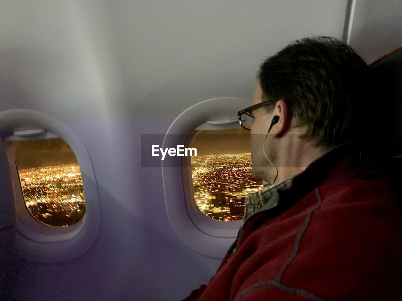 Man looking through airplane window