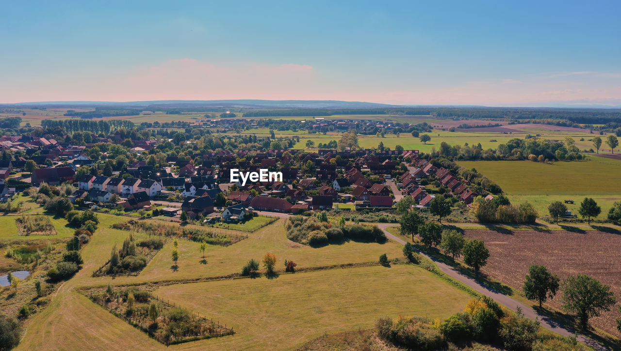 Overview of a suburb ener industrial city with fields, meadows and green  in the surrounding area