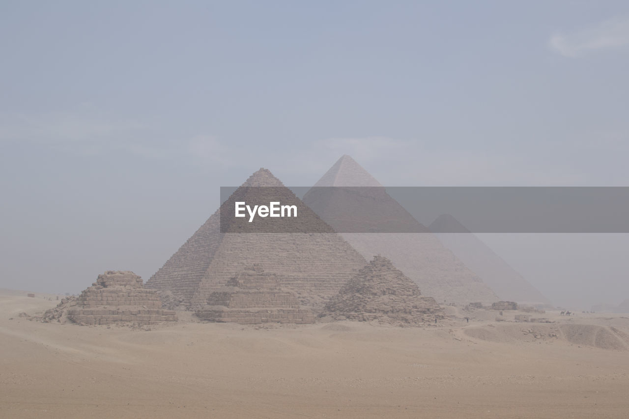 View of egyptian pyramids in light haze