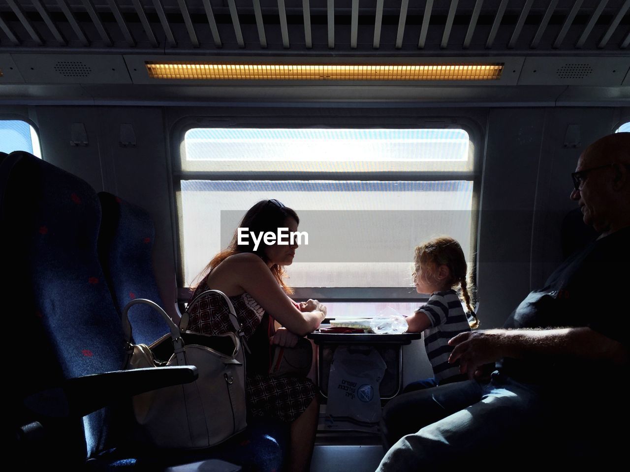 WOMAN SITTING IN TRAIN