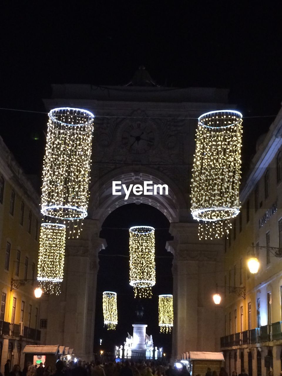 LOW ANGLE VIEW OF ILLUMINATED CITY AT NIGHT